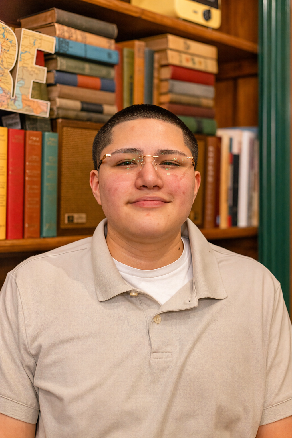 Portrait photo in front of a bookshelf
