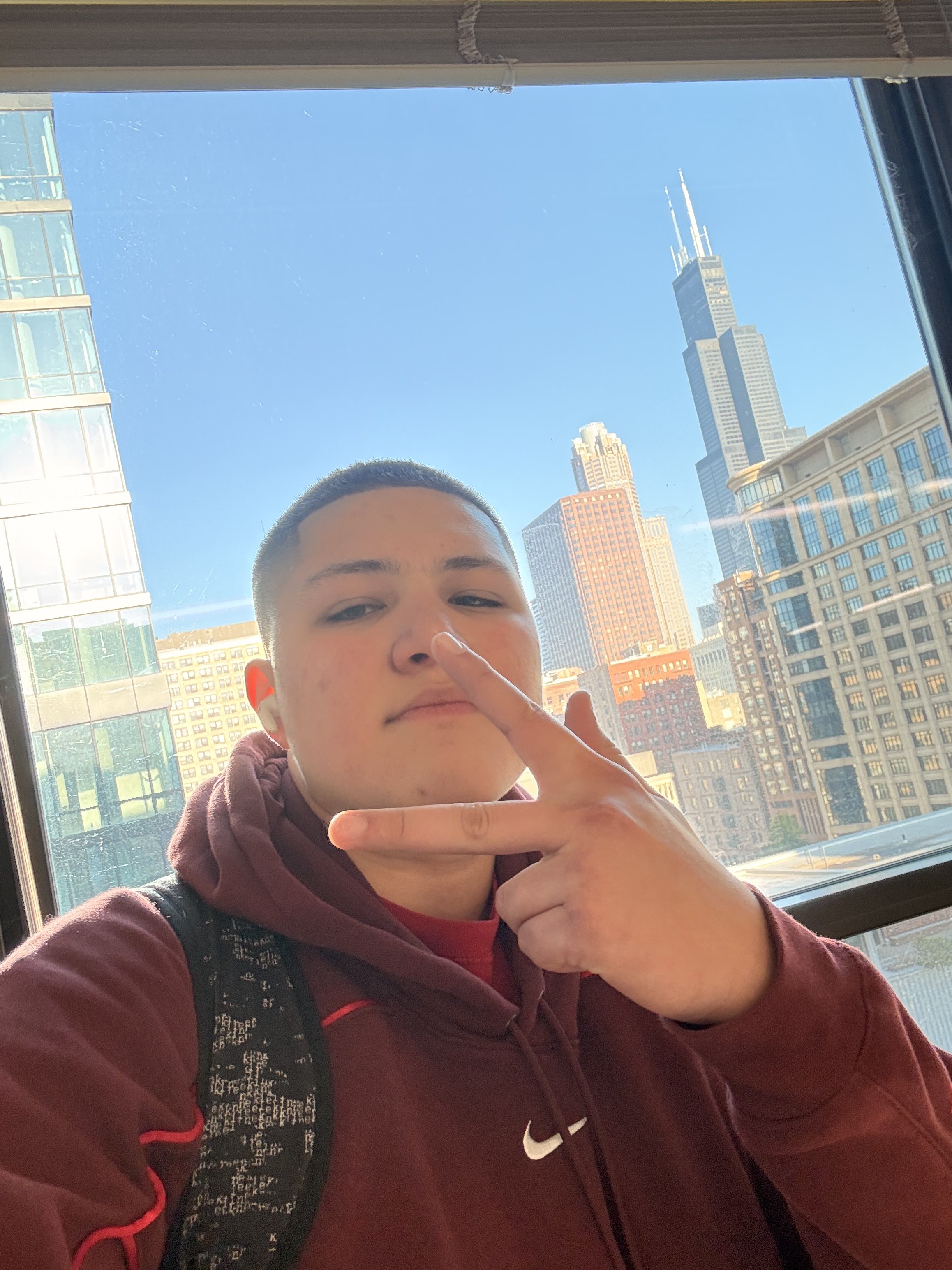 Selfie with Willis Tower visible through a window