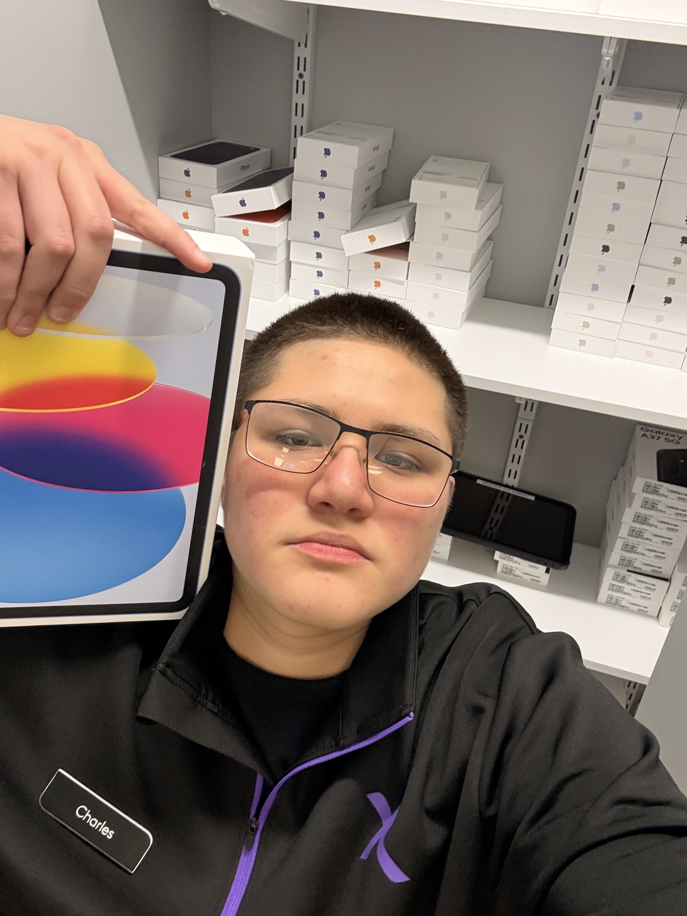 Charles holding an iPad box at the Xfinity store